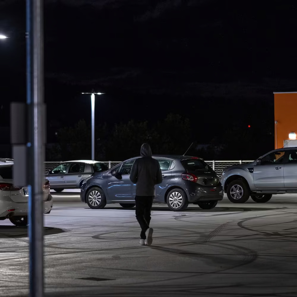 686418cbe069cd4e3a8ac5d5_automotive-intro-dark-parking-lot-person